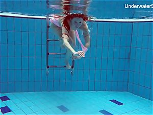 ginger-haired Simonna flashing her assets underwater